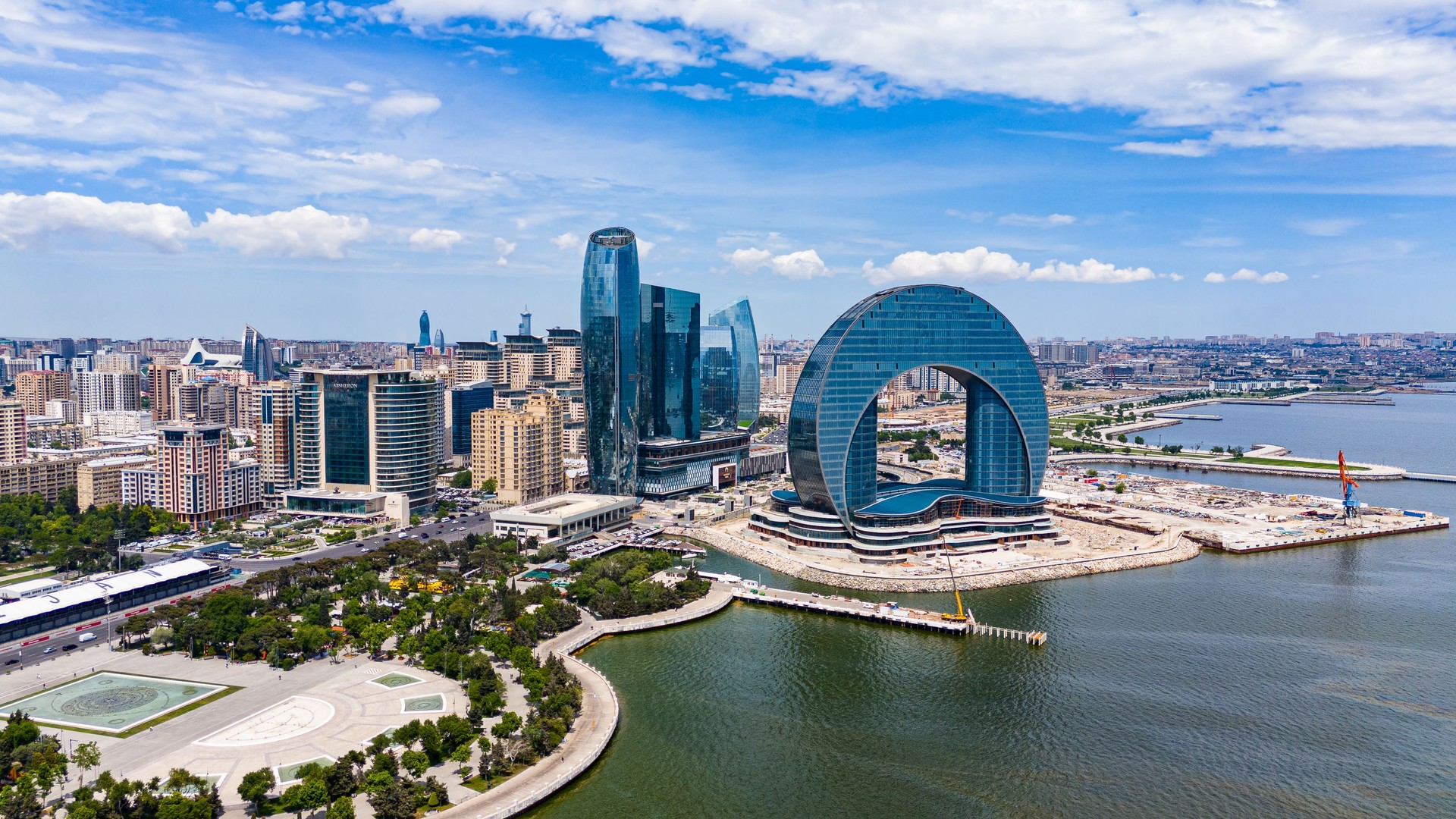 Aerial view of Azerbaijan skyscrappers, Azerbaijan Building of the Crescent Baku Hotel is in shape of a crescent, Crescent Development Project at Sunset Along Caspian Sea Coast Baku, Aerial view of Azerbaijan popular destinations